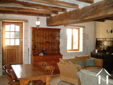The main entrance to the property opens into the sejour. This pictures shows the impressive oak beams and exposed stone walls.
