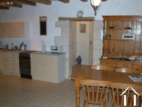 The modern kitchen units are fitted to one corner of the sejour.