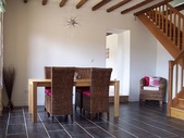 The dining area with oak staircase leading up to a large corridor/mezzanine, three bedrooms and a bathroom.