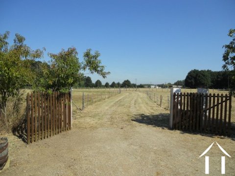 The approach is a long driveway that cuts through the 7.5 acres of ground that surround the house.