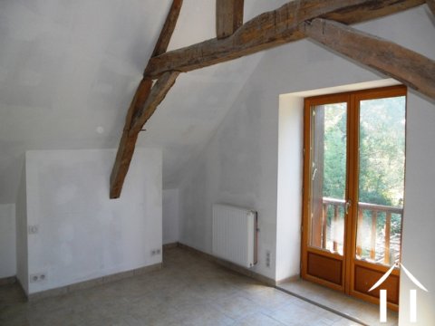 The master bedroom with its view of the land and beyond the pastures of an equistrian centre.