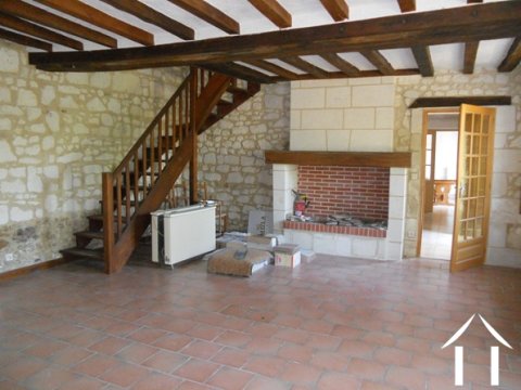 This is the original lounge with its fireplace. From here a staircase rises to two double bedrooms and the large modern family bathroom.