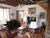 The lounge with its high ceilings and feature fireplace. This room has good light and has direct access to the the courtyard (to the front of the property).