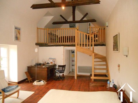 The staircase leading to the mezzanine. Beyond is access to a small loft area, which is ideal for storage.