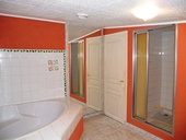 The family bathroom with corner bath, washbasin, enclosed WC, walk-in shower and storage/large linen cupboard (not shown in picture).