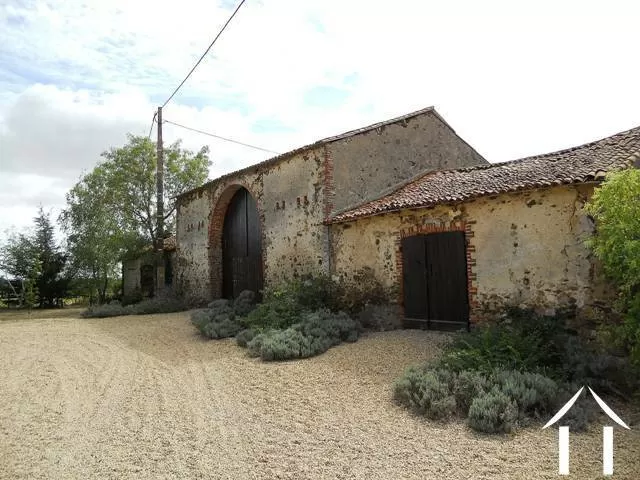 Les annexes, faisant face à la maison et faisant partie d'une cour abritée.  