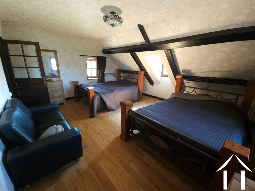 Chambre principale avec poutres apparentes