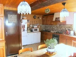 Une partie de la cuisine équipée avec sa salle à manger  