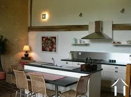 The kitchen in the gîte is both modern and American-style and faces into the lounge area.