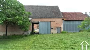 the brick barn seen from the orchard